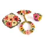 A small group of floral jewellery, with applied clay flower detailing, comprising two brooches and a