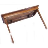 A mahogany folding table, the rectangular crossbanded top above a plain frieze on two hinged square