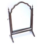 A mahogany dressing mirror, with arched plate, on reeded supports, 44cm wide.