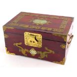 An oriental jewellery box, with brass borders inset with a green coloured stone, 31cm wide.