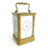 A late 19th/early 20thC French brass carriage clock, the white enamelled dial stamped Philip Hart, L