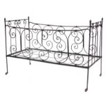 A Victorian wrought iron folding child's cot or bed, with scroll decoration, later painted black, 11
