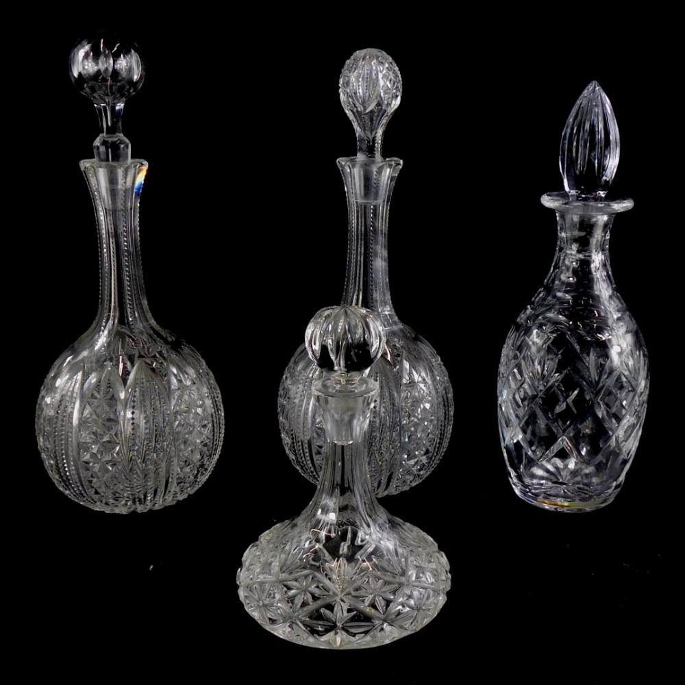 A pair of cut glass bottle shaped decanters and associated stoppers, and two other further cut glass