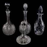A pair of cut glass bottle shaped decanters and associated stoppers, and two other further cut glass