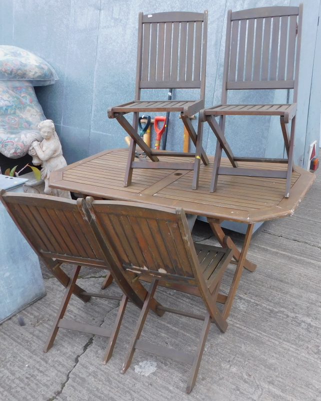 A teak garden table and four folding chairs, various garden tools, to include spades, forks, etc. (a