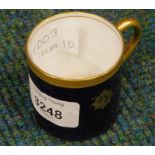 An early 20thC Royal Worcester coffee can, in gilt and blue with crest, Z1070 J, pink printed mark b