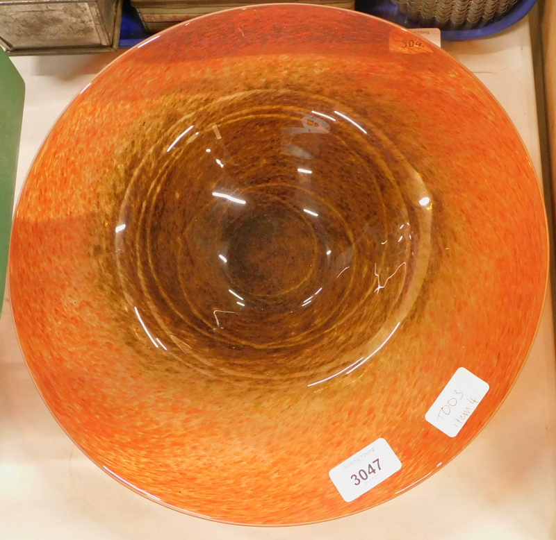 A Monart type glass dish, of circular form in speckled orange and brown colour way, unmarked, 35cm d