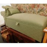 A green upholstered day bed/ottoman.