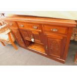 A late 19th/early 20thC walnut sideboard, the two panelled doors decorated with flowers, leaves, etc