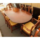 A mahogany twin pedestal extending dining table, and six Hepplewhite style chairs, with drop in seat