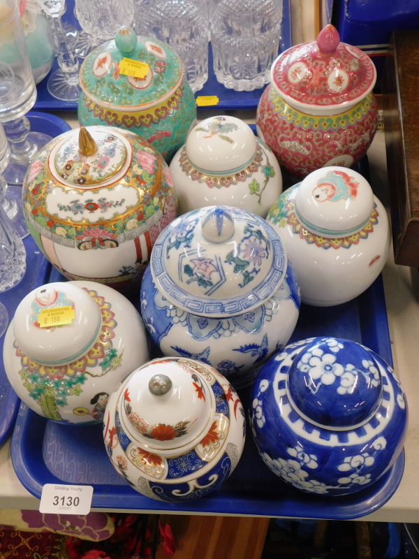 A collection of Oriental style jars and covers, to include blue and white example, etc. (1 tray)