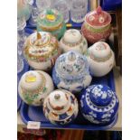 A collection of Oriental style jars and covers, to include blue and white example, etc. (1 tray)