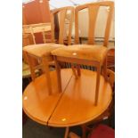 A teak Sutcliffe Furniture extending dining table, on four splayed legs, and four associated chairs.