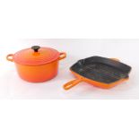 A Le Crueset burnt orange two handled iron casserole dish, and griddle pan. (2)