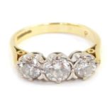 An 18ct gold three stone diamond ring, the central round brilliant cut stone in four claw setting, 4