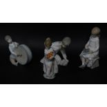 Four Lladro figures of children, three marked Lladro, child with chalk board, unmarked, the tallest