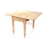 A Victorian stripped pine Pembroke table, the top with rounded corners, above a frieze drawer, on tu