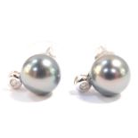 A pair of Tahitian black cultured pearl and diamond earrings, set in white metal stamped 14K, pearl