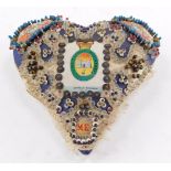 A WWI sweetheart's pin cushion, decorated with The Suffolk Regiment badge and 'Forget Me Not', 18cm