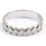 A diamond seven stone half hoop eternity ring, set in white metal, stamped 18k, approximately a 0.25