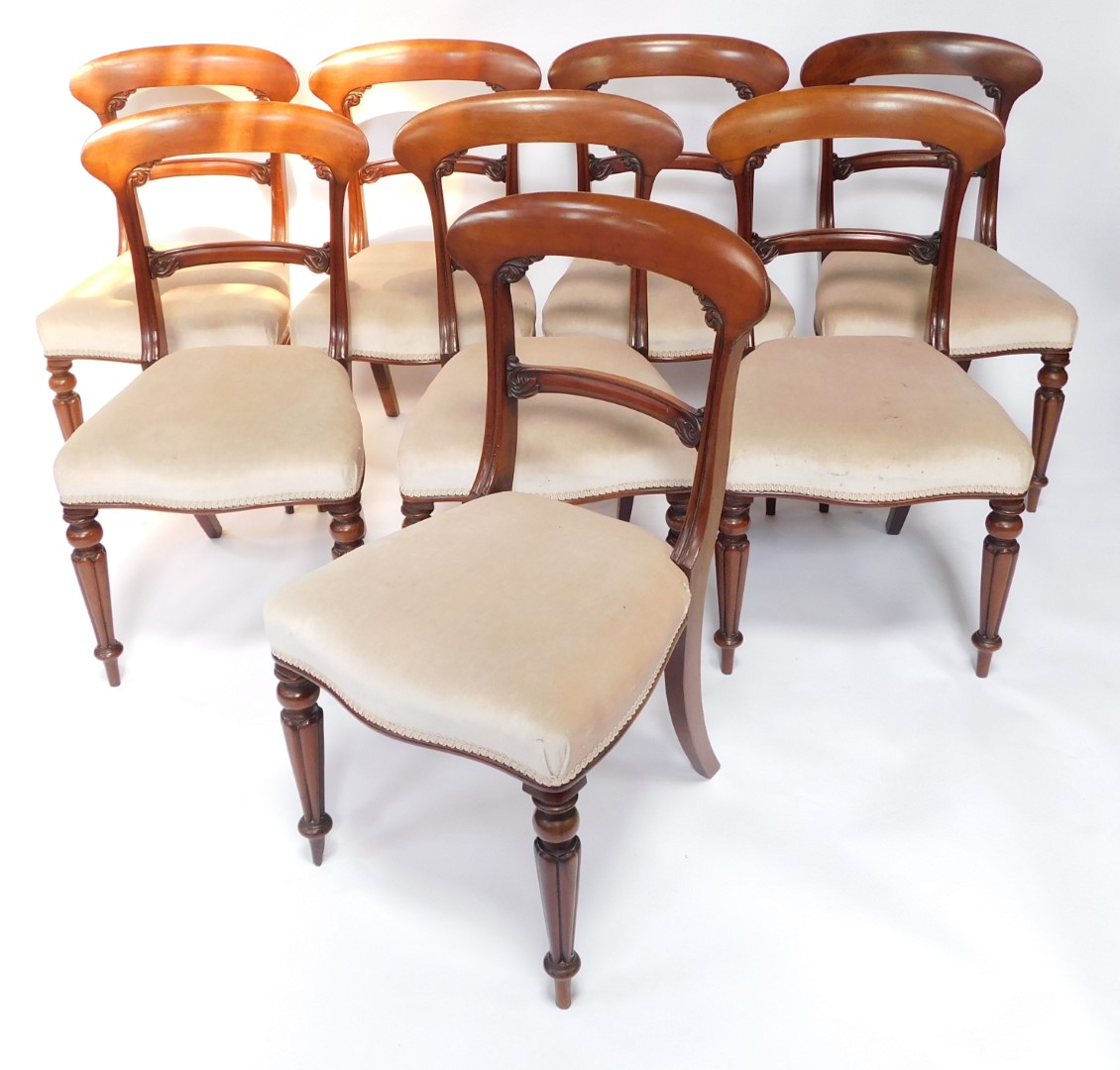 A set of eight Victorian mahogany dining chairs, each with a shaped leaf carved bar back, a padded s