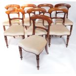 A set of eight Victorian mahogany dining chairs, each with a shaped leaf carved bar back, a padded s