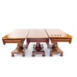 An early Victorian mahogany triple pedestal dining table, comprising a drop flap centre table and tw