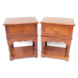 A pair of oak side cabinets, each with a rectangular top and a moulded edge, above a frieze drawer,