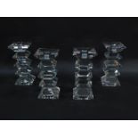 A set of four cut glass candlesticks, of five sectional form, 22.5cm high. (AF)