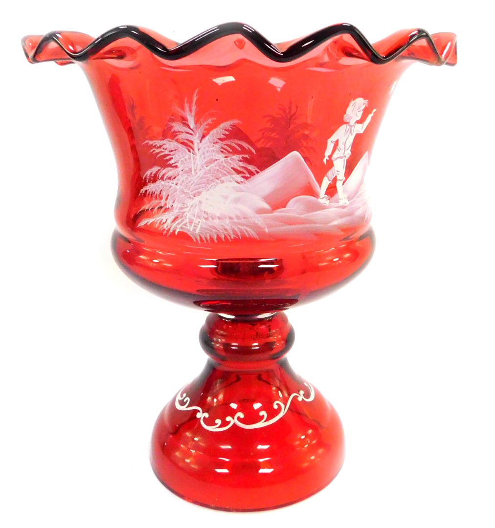 A Victorian cranberry glass vase, decorated in the Mary Gregory style, having a wavy rim and a band