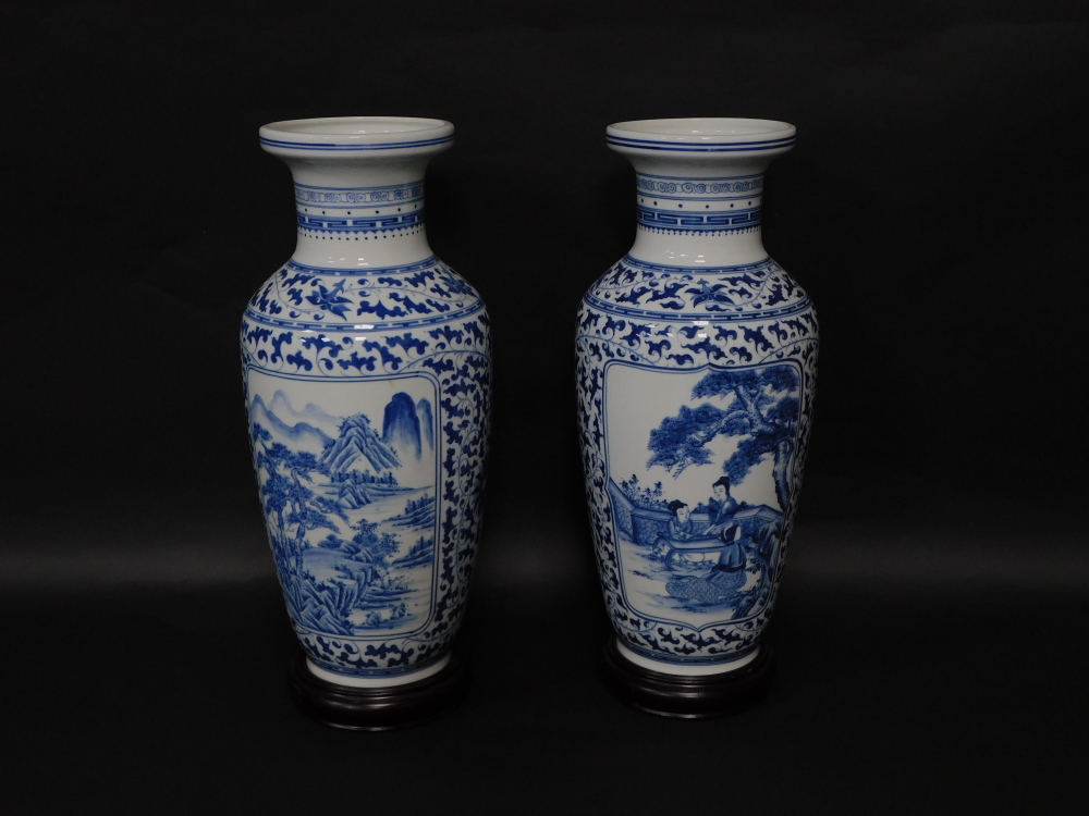 A pair of Chinese porcelain baluster vases, having blue and white landscape decoration, 54cm high wi - Image 2 of 3