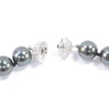 A Tahitian black cultured pearl necklace, on a paste set screw ball clasp, each pearl approx 10mm di