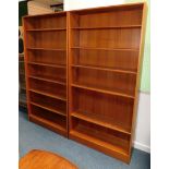 A pair of 1970s teak open bookcases, each with adjustable shelves, on a plinth, 187cm high, 91cm wid