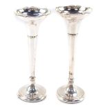 Two George V silver bud vases, having a moulded bowl, above a tapering cylindrical stem with flared