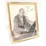 A signed photograph of Sir Noel Coward, dedicated "for David from Noel Coward", in a strut frame.