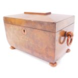 A Victorian figured walnut sarcophagus tea caddy, with loop handles, raised on bun feet, 25cm wide.