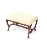 A Georgian style mahogany stool, upholstered in overstuffed cream draylon, raised on cabriole legs,