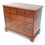 A George III mahogany chest, of two short over three long graduated drawers, raised on bracket feet,