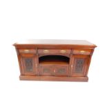A Victorian mahogany sideboard, with three cushion drawers, over a central recess, above a pair of c