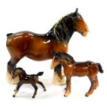 Two Beswick pottery foals, and a associated pottery shire horse. (3)