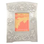 An Arts & Crafts pewter wall mounted photograph frame, embossed with flowers, berries and leaves, ap