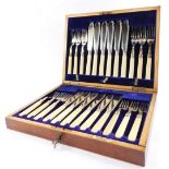 A silver plated fish canteen of cutlery, with silver ferrules and ivory handles, mahogany cased wit