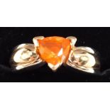 A fire opal ring, trilliant cut, set in yellow metal stamped 14k, approximately 1ct, size M, 6.60g.