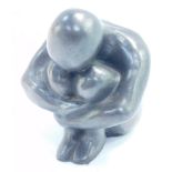 A modernist grey stone metal figure of a crouching figure, 8.5cm high.