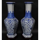A pair of Chinese blue and white hexagonal baluster vases, decorated in a floral blue and white patt