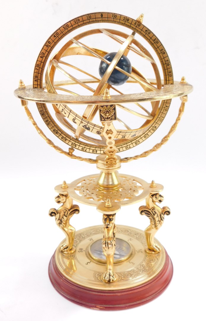 A brass orrery, with an astrological plate, raised on four supports above a table type base on three - Image 2 of 4