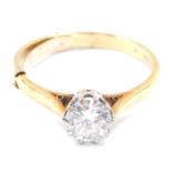 A diamond solitaire ring, high claw set in yellow metal, stamped 18ct, approx 1ct, size Q, 3.6g.