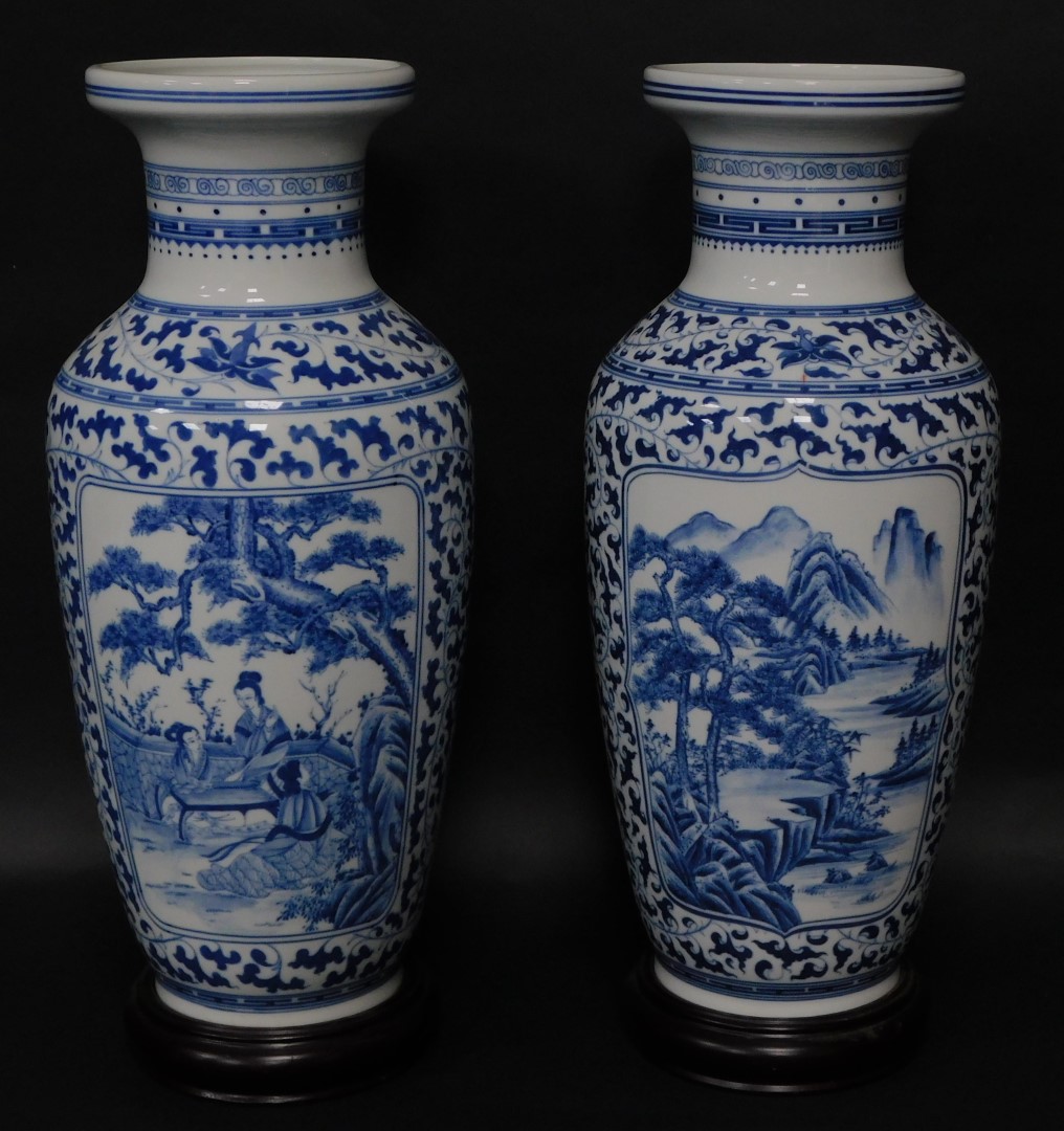 A pair of Chinese porcelain baluster vases, having blue and white landscape decoration, 54cm high wi