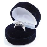 A diamond three stone ring, claw set in white metal, stamped 14k, approximately 1.75cts, size N, 5.0