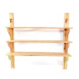 A set of three Victorian pine scullery shelves, with shaped end supports, 140cm high, 158cm wide.